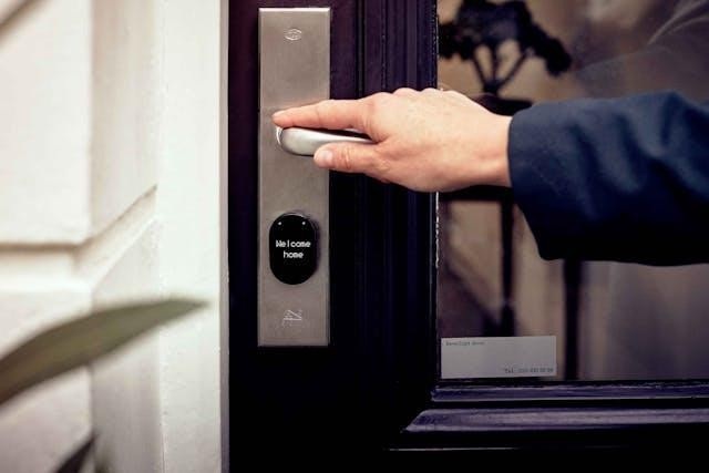 Person with their hand on a door handle that says “welcome home